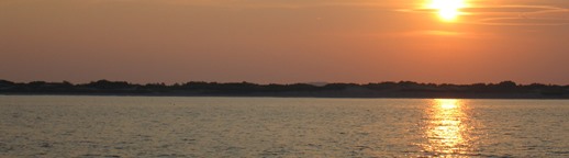 Landscape photo of sunset over Plum Island, taken from on board R/V Connecticut